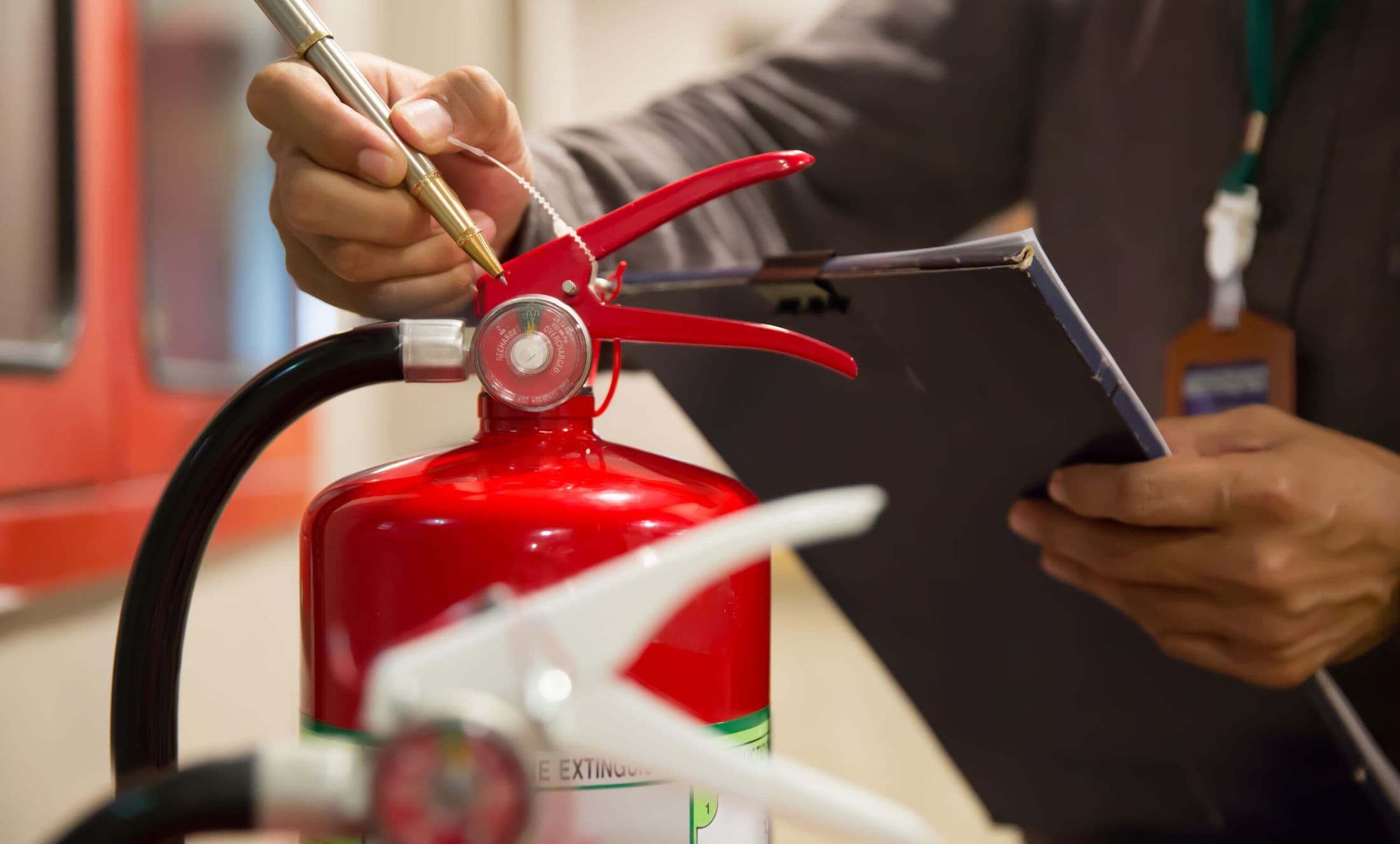 Engineer inspecting a fire extinguisher